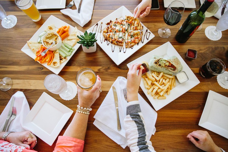 Vegetables, pizza, wrap, fries on table